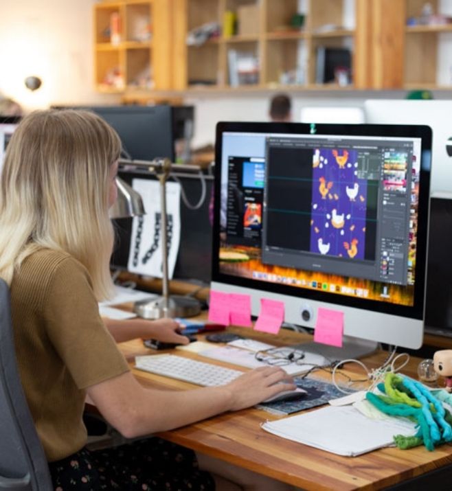 Sock Club designer preparing custom sock artwork on a desktop computer