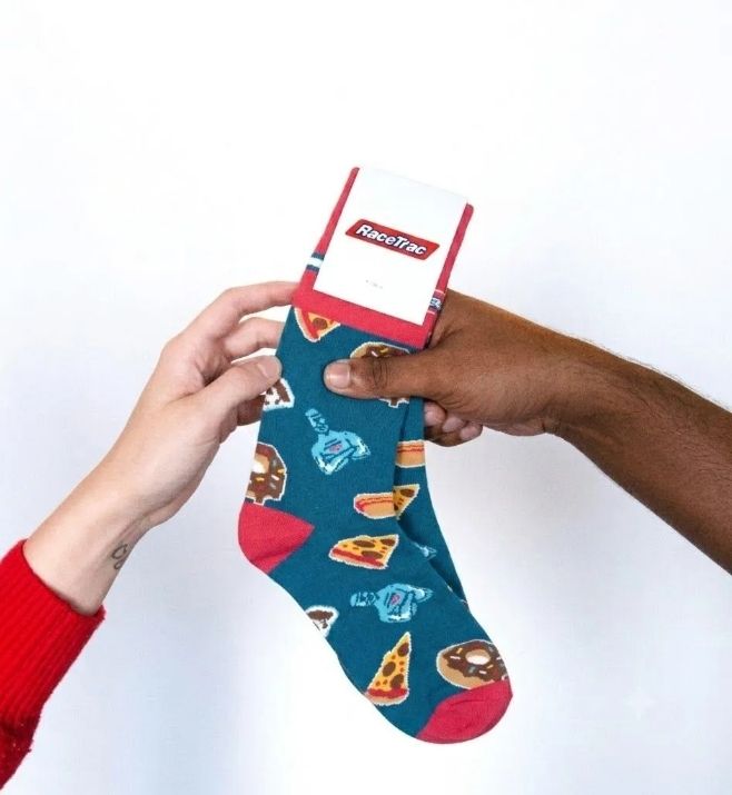 Two people holding a finished custom RaceTrac sock