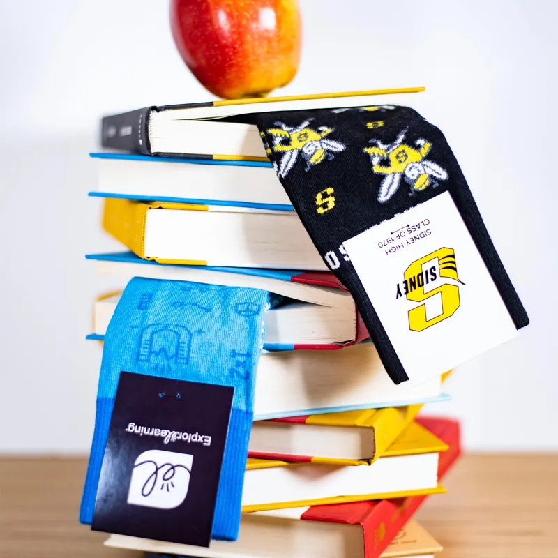 Custom school socks on a stack of books