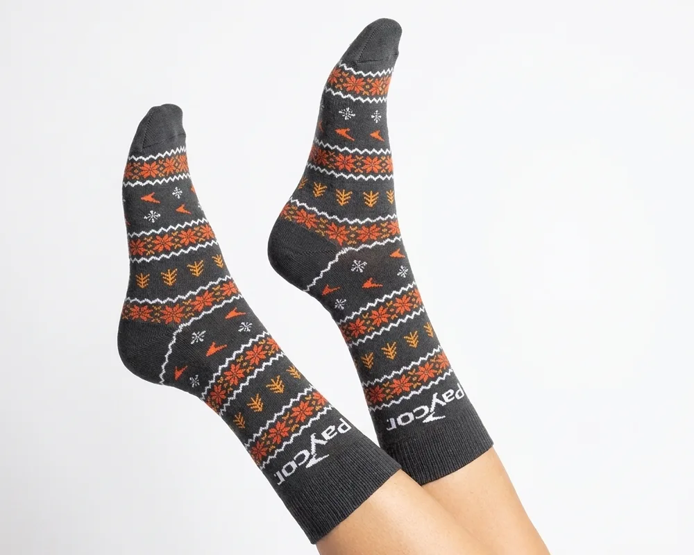Custom holiday socks with a knitted fair isle pattern and logo worn with feet in the air